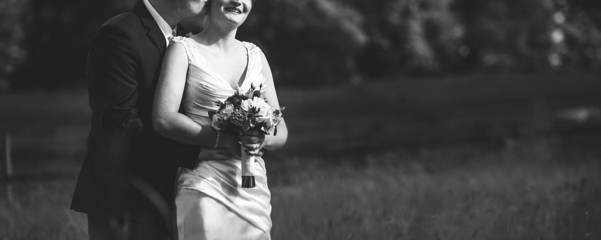 black and white portrait of newlyweds in the open fields surrounding Slaters Country Inn