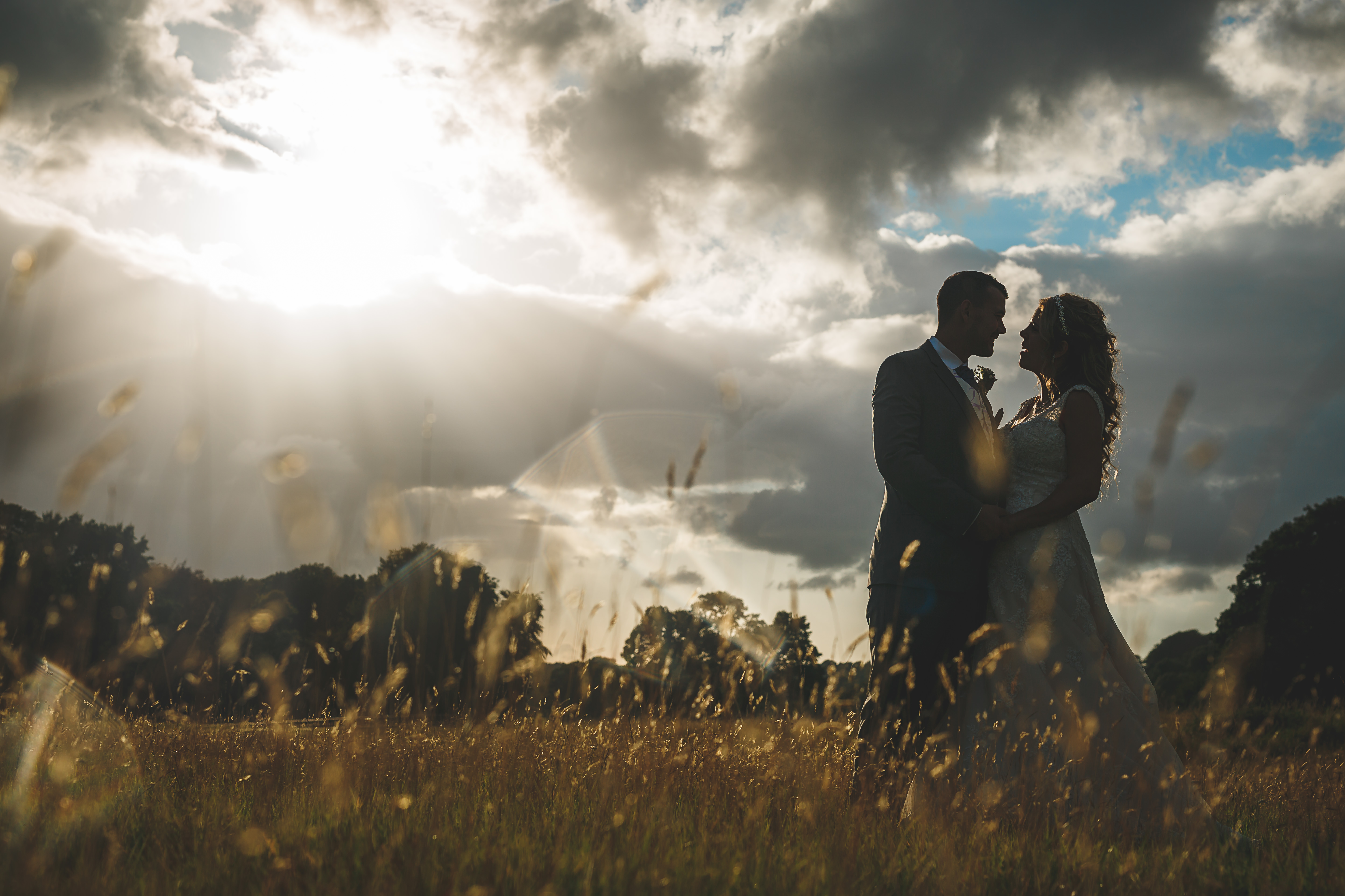 epic sunset picture with bride and groom in a cornfield
