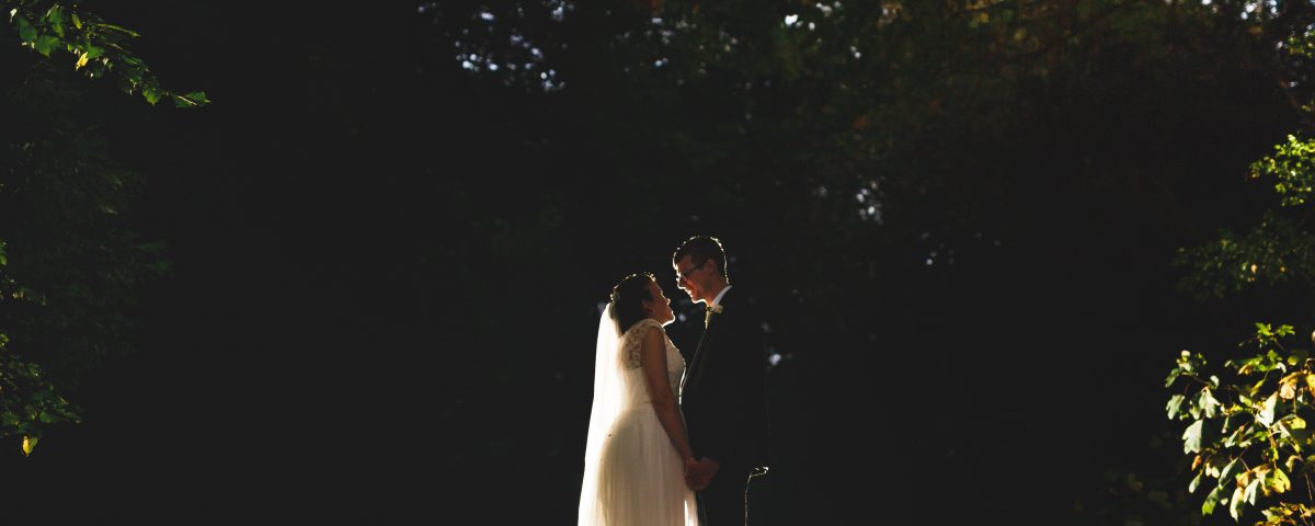 bride and groom kissing woodland donington park farmhouse wedding